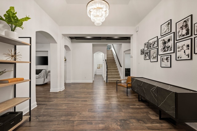 hallway featuring a notable chandelier and dark hardwood / wood-style flooring