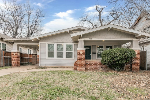 view of front of property with a carport and a front lawn