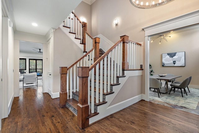 stairway featuring ceiling fan and hardwood / wood-style floors