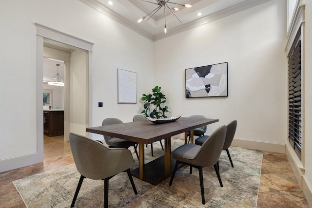 dining space with a high ceiling, a chandelier, a raised ceiling, and crown molding