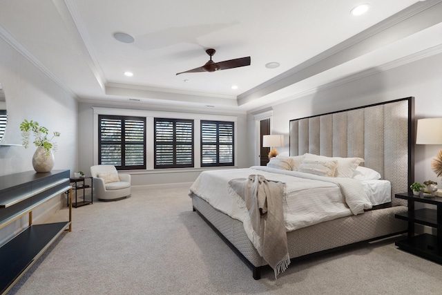 bedroom featuring ceiling fan, carpet, a raised ceiling, and crown molding