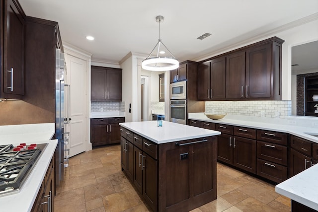 kitchen featuring dark brown cabinets, pendant lighting, a center island, decorative backsplash, and stainless steel appliances