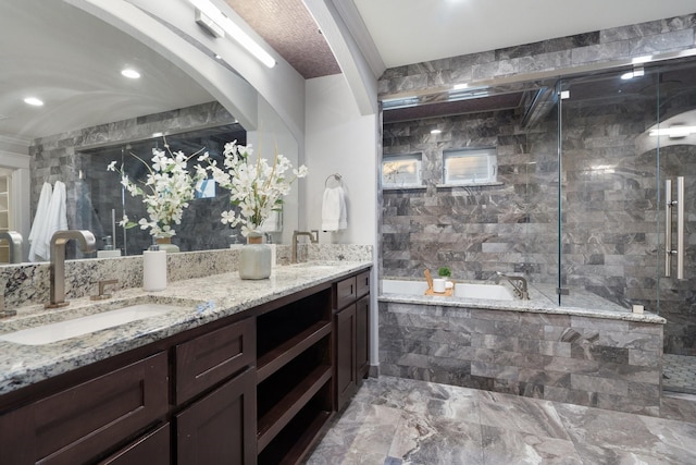 bathroom featuring vanity and independent shower and bath