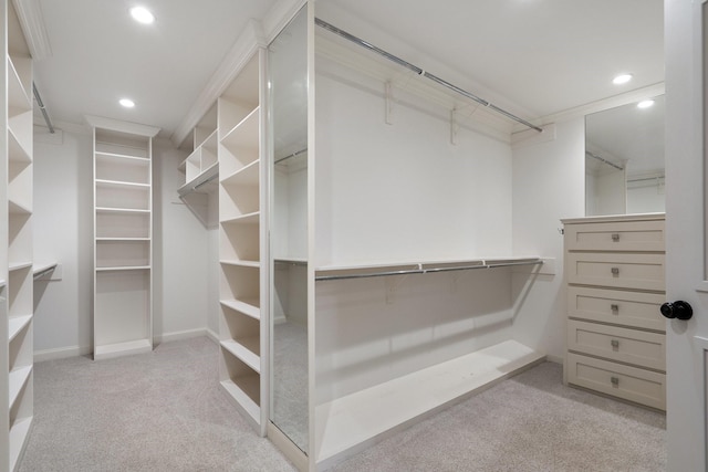 walk in closet featuring light carpet