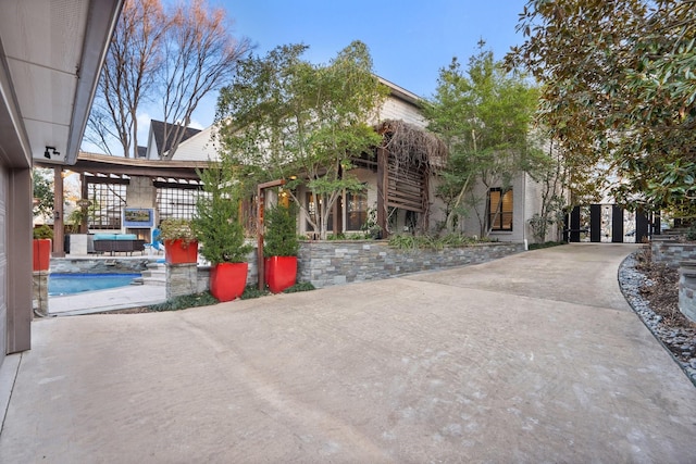 view of front of property featuring a swimming pool