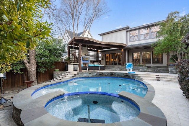 view of pool featuring an in ground hot tub, a patio, and ceiling fan