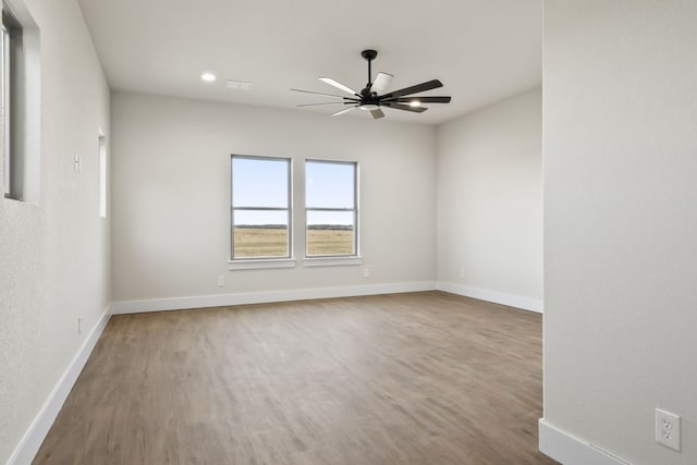 unfurnished room featuring ceiling fan and hardwood / wood-style flooring