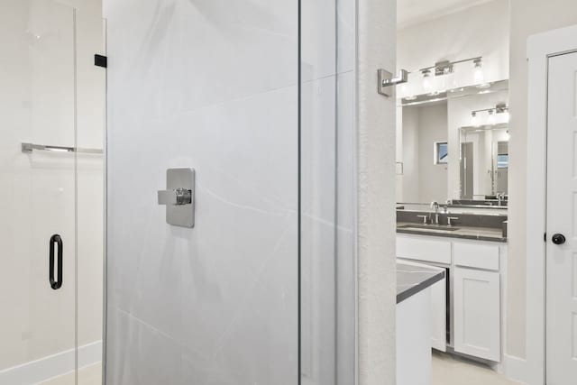 bathroom featuring vanity and a shower with shower door