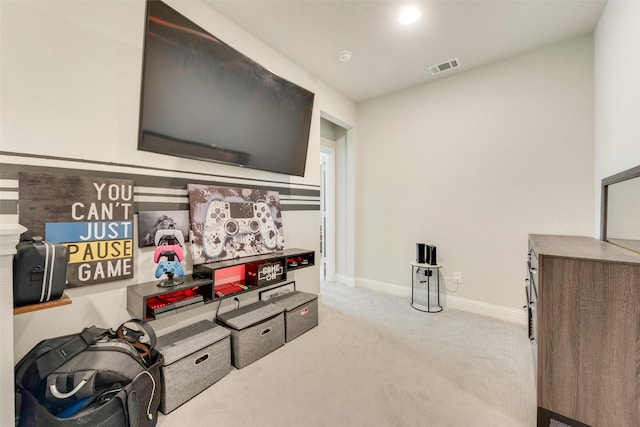 recreation room featuring light colored carpet