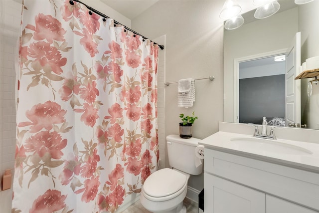 bathroom featuring toilet, vanity, and a shower with curtain