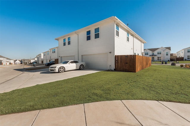 view of property exterior with a garage and a lawn