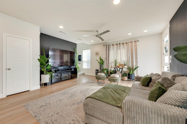 living room featuring ceiling fan and light wood-type flooring