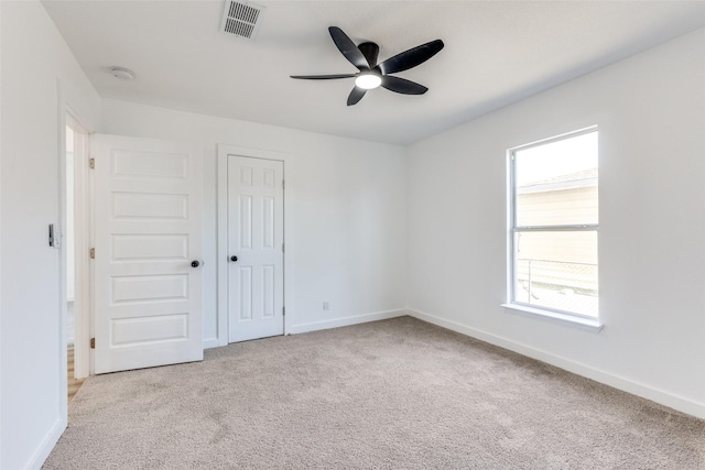 unfurnished bedroom with baseboards, carpet floors, visible vents, and a closet