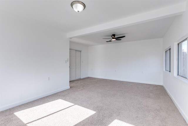 unfurnished bedroom with ceiling fan, light colored carpet, and a closet