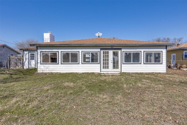 rear view of house with a yard