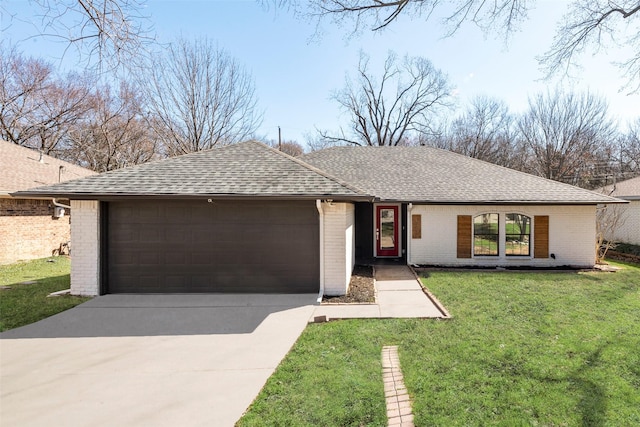 view of front of home featuring brick siding, a shingled roof, a front yard, a garage, and driveway