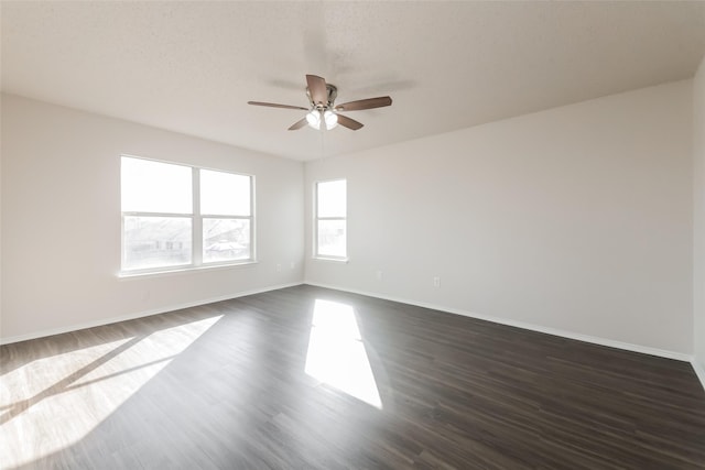 unfurnished room featuring a textured ceiling, dark hardwood / wood-style floors, and ceiling fan