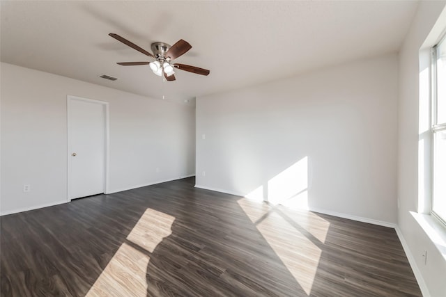 unfurnished room with dark hardwood / wood-style floors and ceiling fan