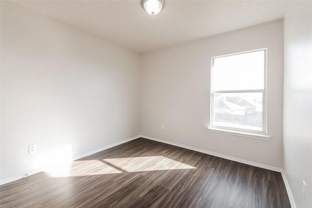 unfurnished room with dark hardwood / wood-style floors