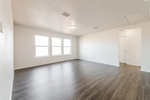 unfurnished room featuring a textured ceiling and dark hardwood / wood-style floors