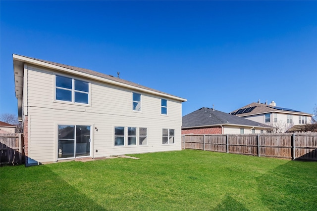 back of house featuring a yard