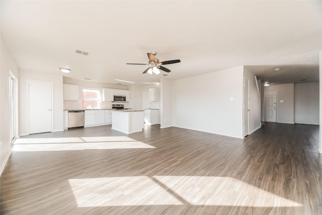 unfurnished living room with ceiling fan and hardwood / wood-style floors