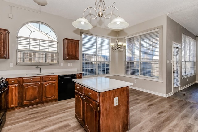 kitchen with dishwasher, a kitchen island, an inviting chandelier, light hardwood / wood-style floors, and sink