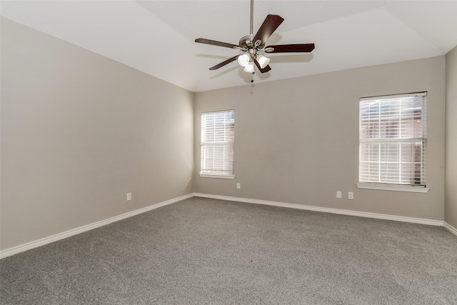 carpeted spare room featuring ceiling fan