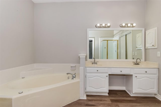 bathroom with vanity, independent shower and bath, and hardwood / wood-style floors