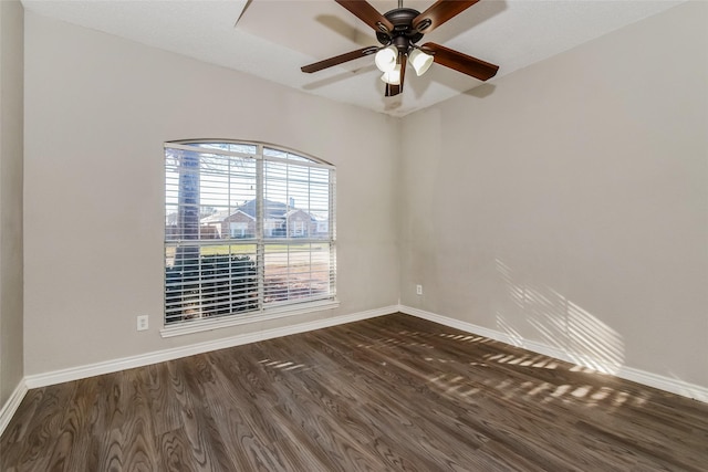 spare room with ceiling fan and dark hardwood / wood-style flooring