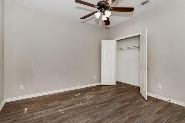 unfurnished bedroom featuring a closet, ceiling fan, and dark hardwood / wood-style flooring