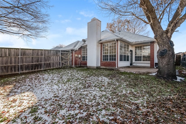 snow covered property featuring a patio area