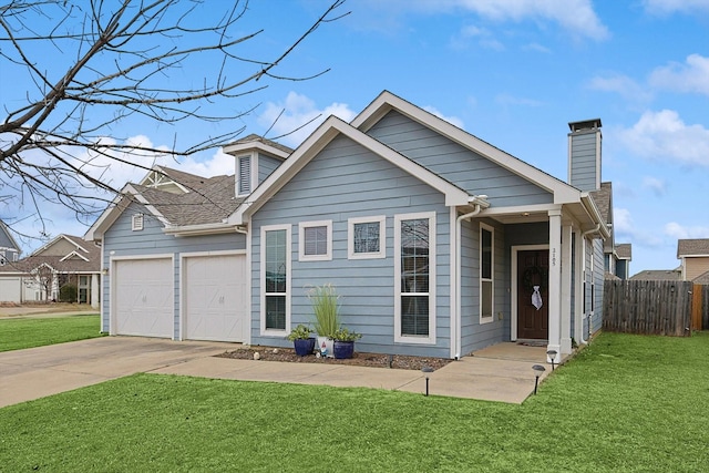 view of front of property featuring a garage and a front lawn