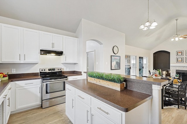 kitchen with light wood finished floors, dark countertops, open floor plan, stainless steel electric range, and under cabinet range hood