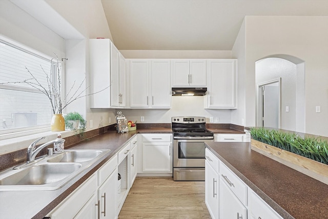 kitchen with white cabinetry, sink, light wood-type flooring, and stainless steel range with electric stovetop