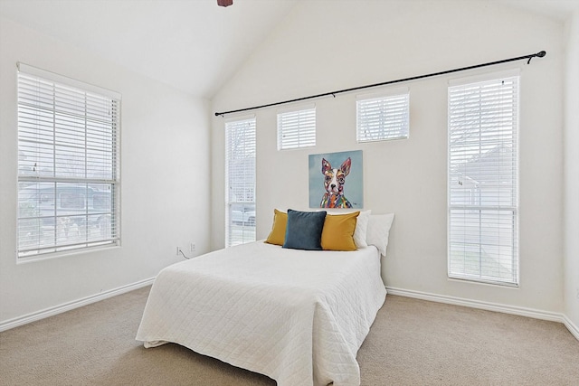 carpeted bedroom featuring lofted ceiling and baseboards