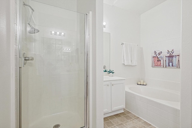 full bath featuring a stall shower, a garden tub, and vanity