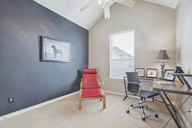 carpeted home office with ceiling fan and vaulted ceiling