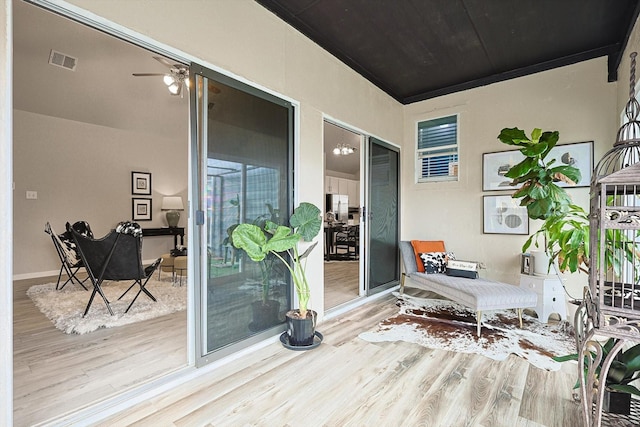 sitting room featuring ceiling fan and light wood-type flooring