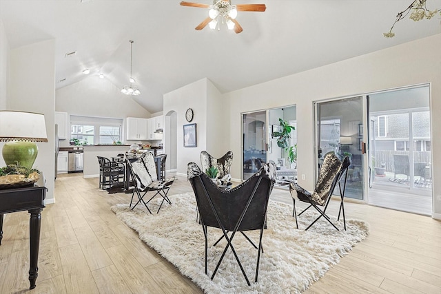 living room featuring ceiling fan, lofted ceiling, and light hardwood / wood-style flooring