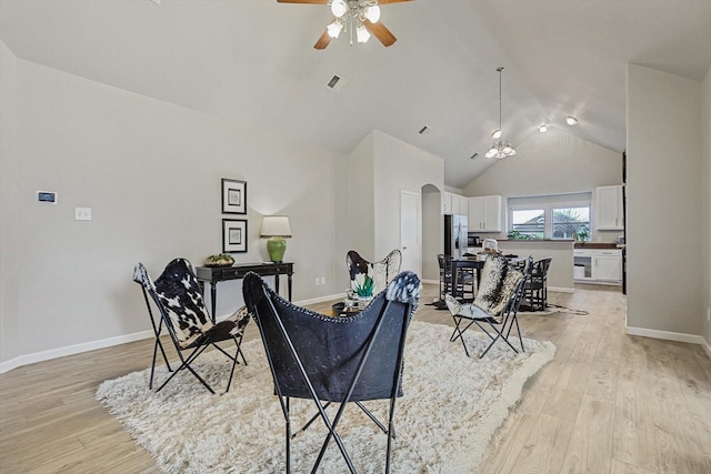 living room featuring ceiling fan, lofted ceiling, and light hardwood / wood-style floors