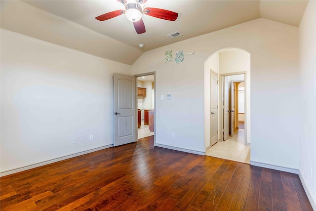 unfurnished bedroom with hardwood / wood-style floors, vaulted ceiling, and ceiling fan