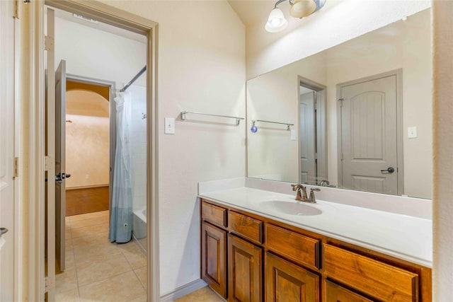 bathroom featuring shower / bath combination with curtain, tile patterned floors, and vanity