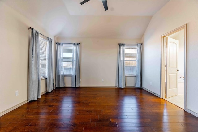 unfurnished bedroom featuring ceiling fan, dark wood-type flooring, multiple windows, and vaulted ceiling