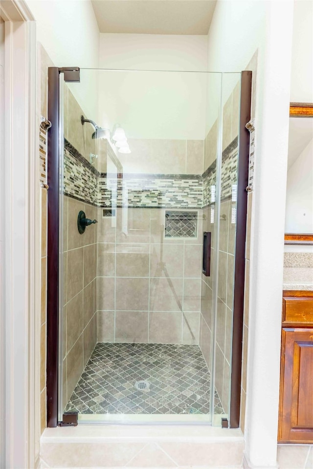 bathroom featuring a shower with door