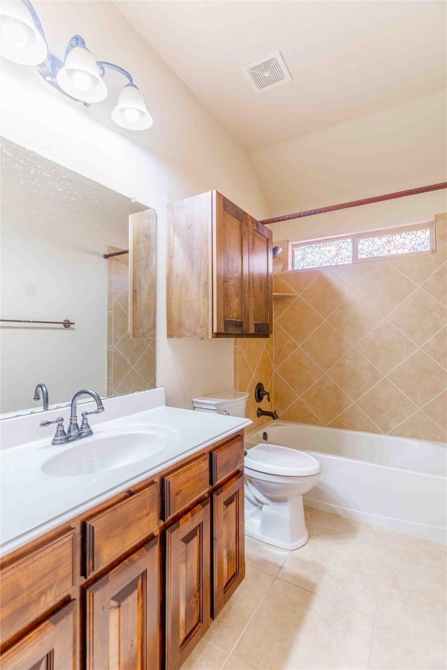 full bathroom featuring tiled shower / bath combo, lofted ceiling, tile patterned flooring, vanity, and toilet