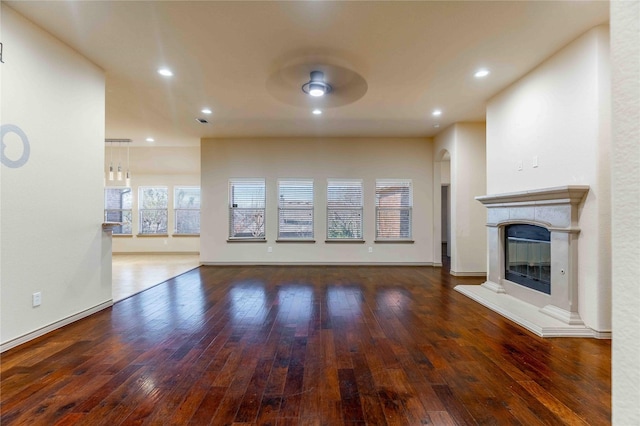 unfurnished living room featuring dark wood-type flooring