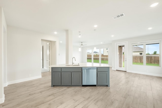 kitchen featuring a sink, gray cabinets, open floor plan, stainless steel dishwasher, and visible vents