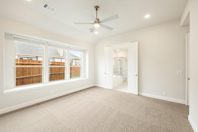 carpeted empty room with visible vents, baseboards, ceiling fan, recessed lighting, and vaulted ceiling