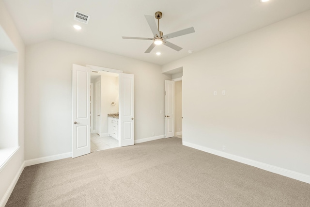 unfurnished bedroom featuring recessed lighting, baseboards, light carpet, and ensuite bath